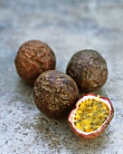 Four passion fruits, whole and halved