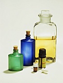 Sandlewood essential oil, storage bottles behind