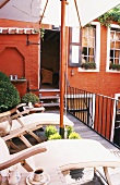 A terrace with a parasol