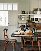 Rustikaler Esstisch und Bistrostühle in einem ehemaligen, zur Küche umgebauten Stall
