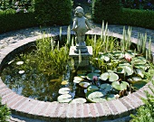 Ornamental pond with water lilies and statue