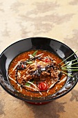 Asian hot and sour soup with shrimps and chocolate sauce