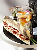 Ham baguette and potato salad with caviar
