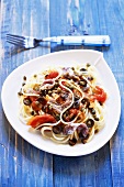 Spaghetti with tomatoes, anchovies, olives and capers