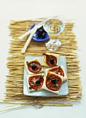 Puff pastry slices with tomatoes, olives and anchovies