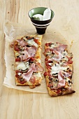 Two ham and mushroom pizza slices