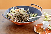 Stir-fried vegetables with strips of beef in wok