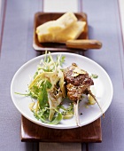 Fried lamb chops with artichoke and rocket salad