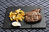 Beef steak with baked potato wedges