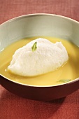 Oeufs à la neige (poached meringue) with custard and basil