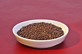 Black mustard seeds in a small dish