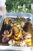 Roast loin of pork with vegetables and herbs