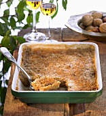 Exotic nut pudding with puff pastry in baking dish