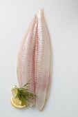 A fresh pangasius fillet with dill and lemon