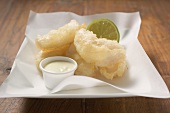 Tempura appetisers with lime mayonnaise on a square plate