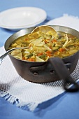 Vegetable soup with noodles in saucepan