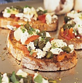 Sheep's cheese, olives and tomatoes on toast