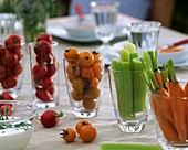 Vegetables in glasses with herb yoghurt dip