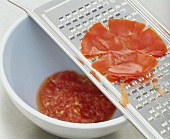 Grating tomato on a vegetable grater