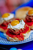 Burgers with tomato sauce and fried eggs