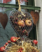 Door wreath & wire netting heart filled with fruit & dried plants