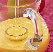 Mango sauce with ginger in glass jug