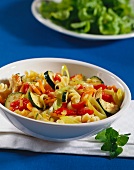 Fusilli with mixed vegetables and strips of chicken breast