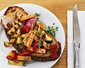 Sausage and grilled vegetable salad on crusty bread