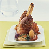 Lamb shank on apple with herbs