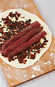 Preparing fillet of lamb in pizza dough