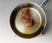 Peppered steak in a frying pan