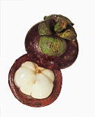 A halved mangosteen against a white background