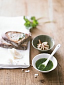 Pesto, slices of bread and pine nuts