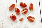 San Marzano tomatoes on paper, some hollowed out