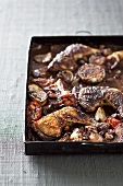 Oven-roasted chicken legs with tomatoes and garlic