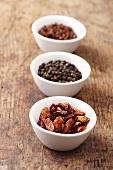 Dried chilli peppers and pepper corns in bowls