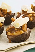 Chocolate tartlets with a pecan & caramel filling and white chocolate