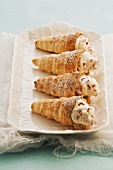 Schillerlocken (spiral-shaped puff pastries) filled with cream