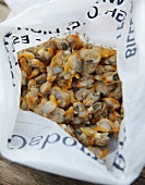 A plastic bag full of mussels, seen from above