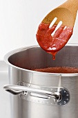 A gelling test being carried out with strawberry jam