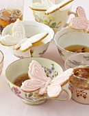 Teatime: tea cups with butterfly biscuits