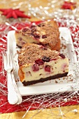 Two pieces of Christmas cherry cheesecake