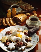 A plate of biscuits with cups of coffee