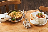 Cheese spätzle (soft egg noodles from Swabia) with fried onions and goulash soup