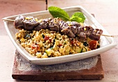 Lamb kebab on a bed of couscous with vegetables