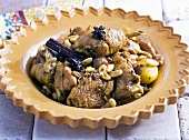 Chicken with cinnamon, almonds, raisins and potatoes