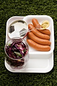 Frankfurters, red cabbages salad and mustard