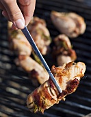 Chicken wrapped in backon on a barbeque