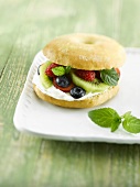 A bagel with fruit and cream