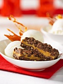 Chocolate-caramel bars with pecan nuts and ice cream